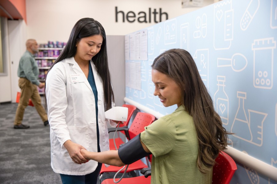 CVS pharmacist tests patient's blood pressure